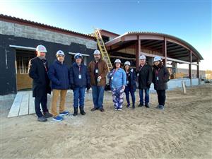 Board Trustees and Superintendent pose outside new fitness center 